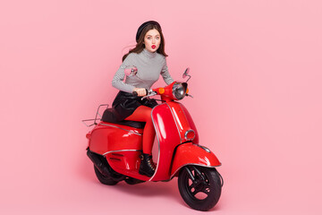 Obraz na płótnie Canvas Photo of stylish trendy lady fashionista ride fast motorbike hurry fashion week wear boots isolated pink color background