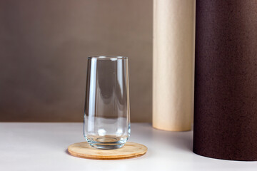 Empty glass on pastel color abstract background. Empty transparent water glass for your drinks.