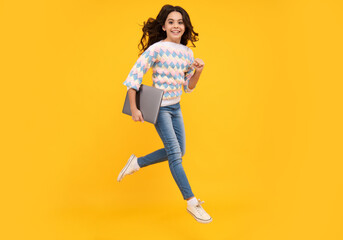 Fototapeta na wymiar Back to school, Teenager school girl with laptop computer. Run and jump, jumping kids.