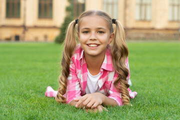smiling teen child portrait relax on green grass outdoor