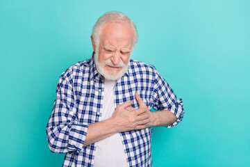 Picture of old pensioner grandfather touching chest suffering from heart attack isolated on teal...