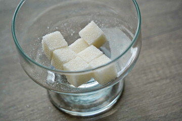 Almaty, Kazakhstan - 03.28.2022 : Sugar cubes are stacked in a glass vase.