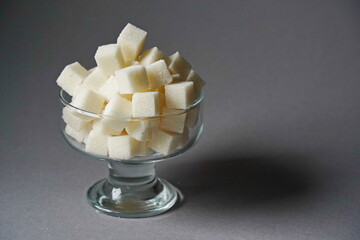Almaty, Kazakhstan - 03.28.2022 : Sugar cubes are stacked in a glass vase.