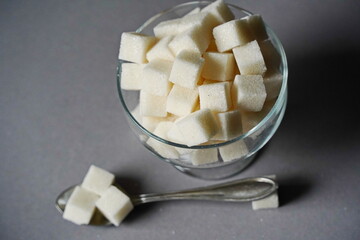 Almaty, Kazakhstan - 03.28.2022 : Sugar cubes are stacked in a glass vase.