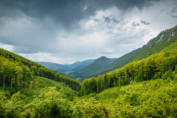 Fototapeta na wymiar Spring cloudy landscape of hills and forests. The Muranska planina plateau national park in central Slovakia, Europe.