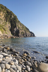 Fototapeta na wymiar The pebble beach in Riomaggiore, Cinque Terre, Italy
