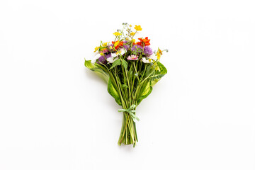 Bunch of wild meadow flowers and herbs chamomile, cornflower and ranunculus. Summer floral background
