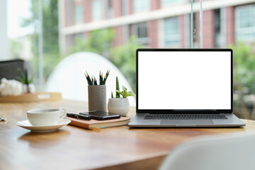 Laptop blank screen on wood table with coffee cafe background, mockup, template for your text,