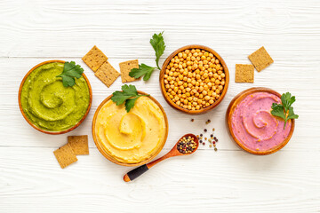 Various types of hummus with chickpeas spinach and beets. Flatlay top view