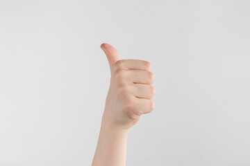 hand of kids or child hand showing thumbs up Isolated on white and gray background