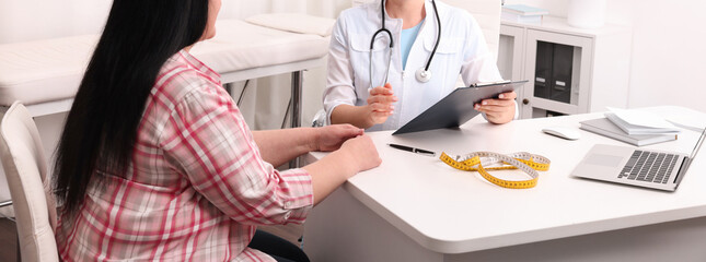 Overweight woman consulting with nutritionist in clinic, closeup. Banner design