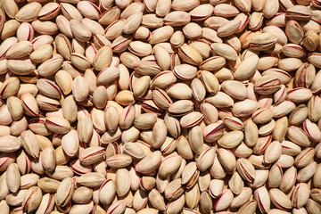 Many tasty pistachios as background, top view