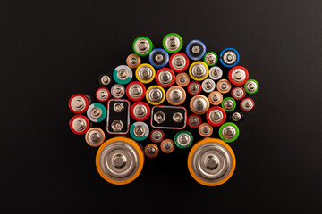 Composition with alkaline batteries on black background. Chemical waste. Top view