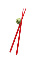 Swirl of wasabi paste and chopsticks on white background, top view