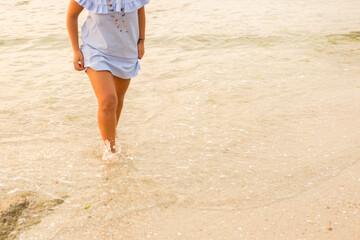 woman walking on the seashore
