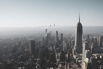Fototapeta na wymiar An aerial view of foggy New York City cityscape with the Empire State Building and One World Trade Center