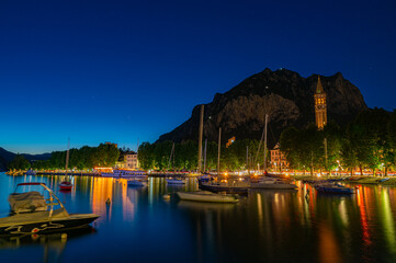 Fototapeta na wymiar The city of Lecco, with its lakefront and its buildings, photographed in the evening.