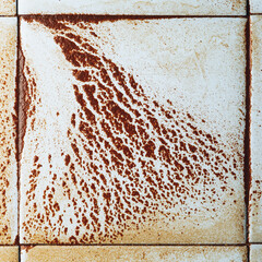 abstract wet rust scattering on a tile background