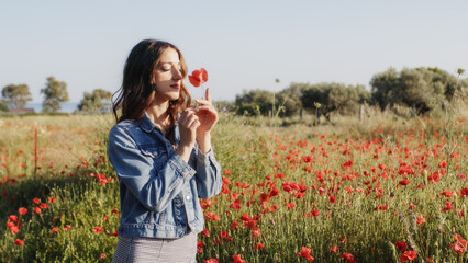 Girl in a wonderful field of red poppies