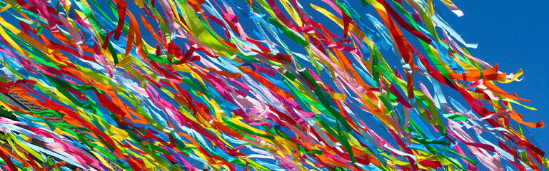 Colorful ribbons on blue sky background	