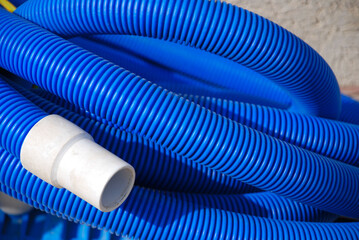 Blue Pool Hose curled up with white connector