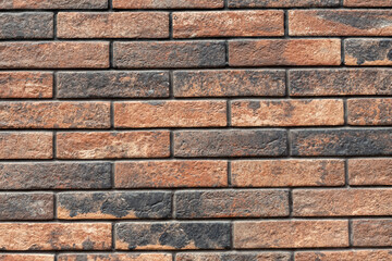 Brick wall background of red and black bricks neatly arranged.