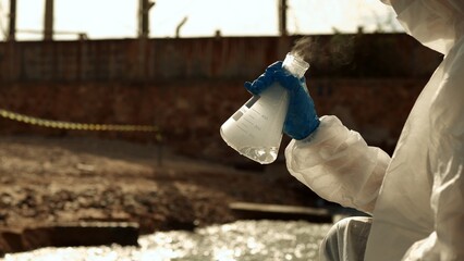 Ecologists sample water contaminated with dangerous, waterhazard toxins into tubes, Scientist or...
