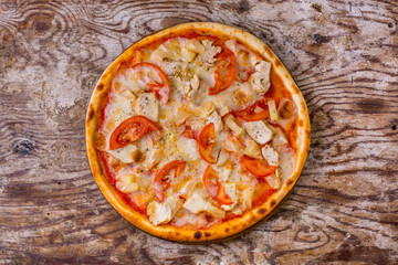 Pizza with tomatoes, pineapple slices, chicken