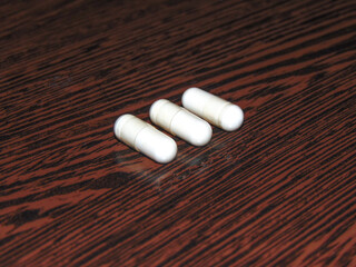 probiotic capsules on a wooden background