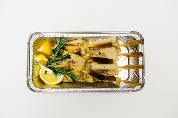 Fried fish in a silver thermal box