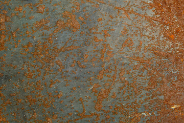 Corrosion. Metal plate with weathered colors and rust. Orange metal plate. Old oxidized colorful textured surface.