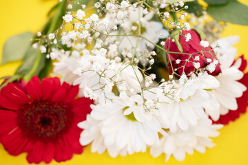 bouquet with chrysanthemums and gerbera, flowers on a yellow background, macro photo