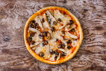 Pizza with chicken breast, sauce, mushrooms and cheese