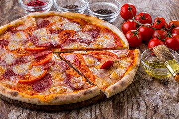 Pizza with tomatoes, sausage and hot peppers