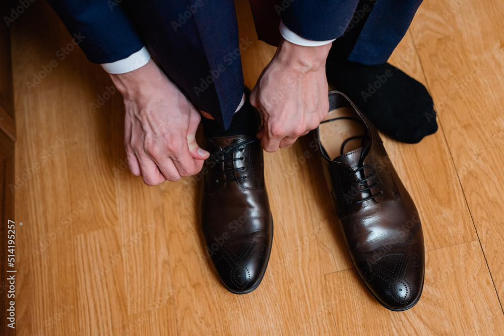 Wall mural legs in black shoes