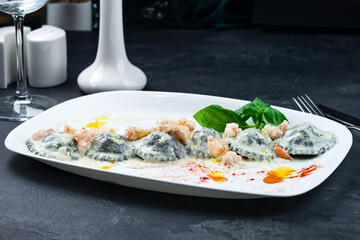 Handmade seafood ravioli with trout and salmon in cream sauce