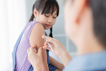 doctor inject vaccine to asian girl, Deltoid muscle injection technique, children immunization and health care promotion