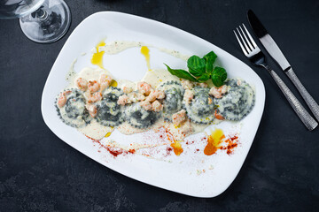 Handmade seafood ravioli with trout and salmon in cream sauce