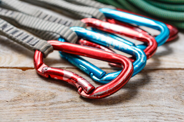 Mountaineering equipment spread out on a wooden table. Quickdraws set, dynamic rope