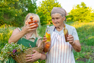 Fototapeta premium A woman makes herbal tincture. Selective focus.