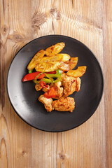 traditional dishes of European cuisine, delicacy, banquet snack. culinary dishes on a black plate on a wood background. restaurant service. top view