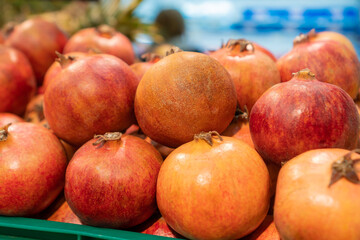 Close-up of fresh ripe large pomegranates on the counter in the store