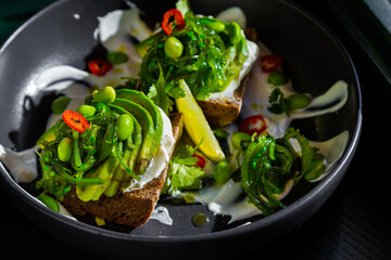 Sandwiches with avocado, beans, chukoy, philadelphia cheese, parsley