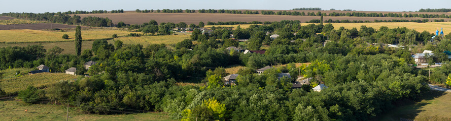 Fototapeta na wymiar Landscapes of the Northern regions of Moldova. A pastoral panorama with nature. Moldovan villages and houses and streets.
