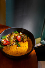Pumpkin porridge with strawberries, apple, mint, avocado, sesame seeds