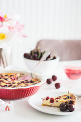 Plate with tasty cherry cheesecake pie on white background