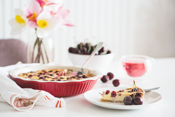 Plate with tasty cherry cheesecake pie on white background