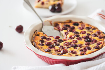 Plate with tasty cherry cheesecake pie on white background