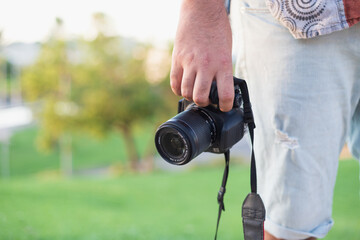 male hand holding reflex camera