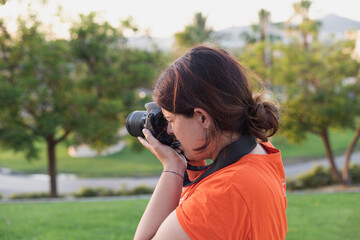 woman taking pictures in the park